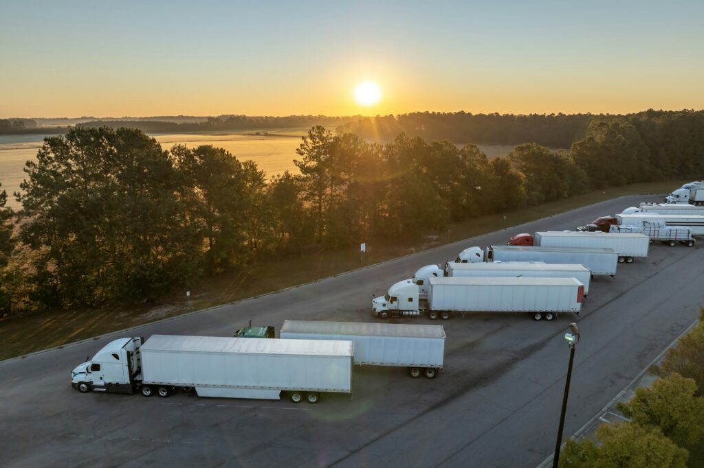 Rest area for semi trucks near busy interstate freeway. Truck stop place during hauling cargo